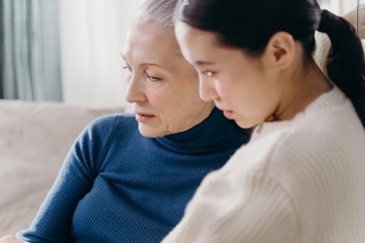A loving bond between an elderly woman and a younger adult indoors.